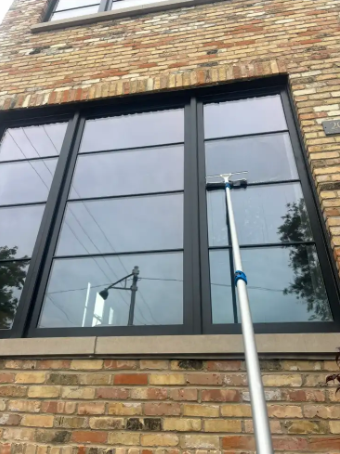 Cleaning large windows on a brick home